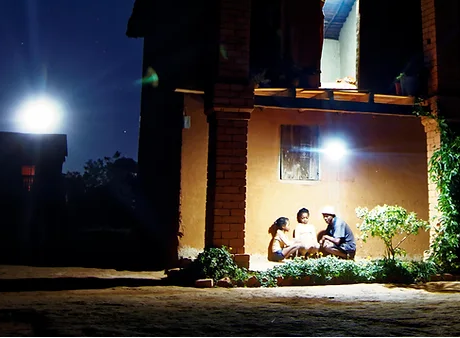casa africana iluminada de noche con equipo de baobab+